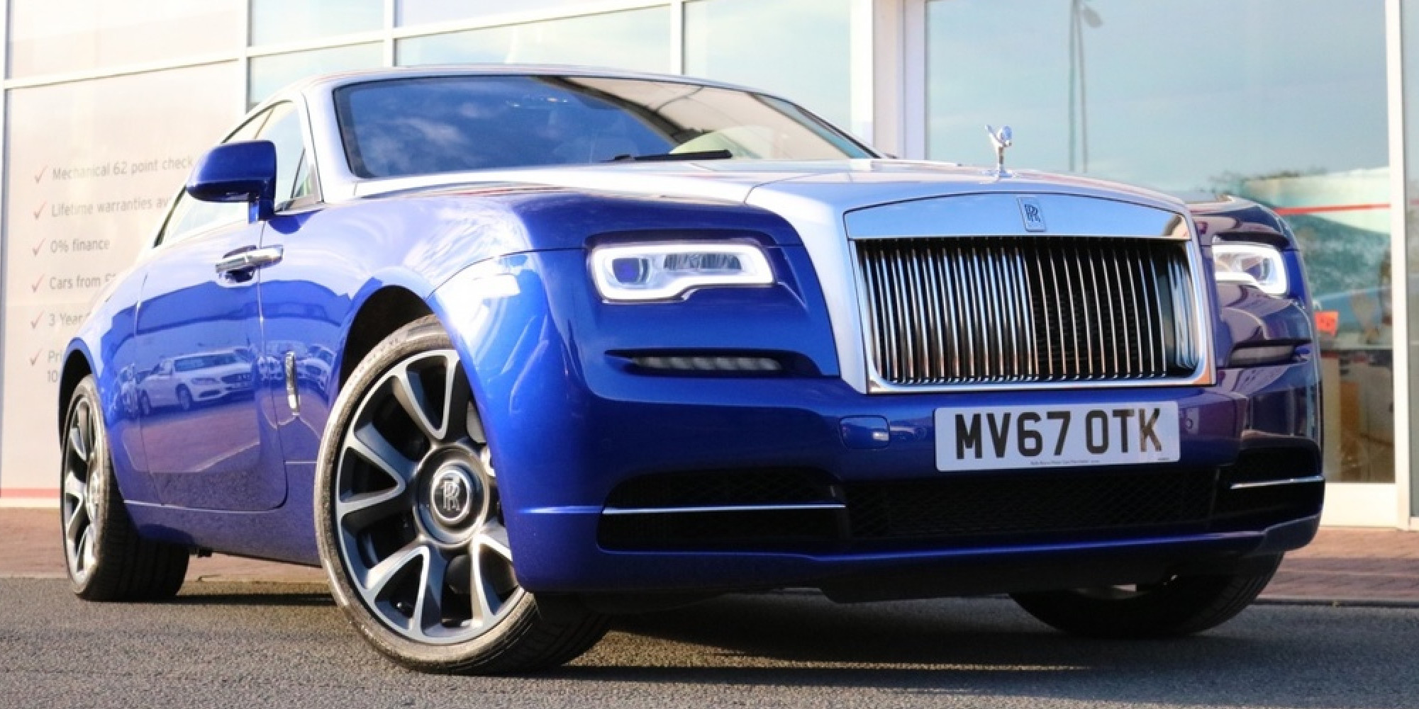 Blue Rolls Royce Wraith  with grey bonnet parked three-quarters facing right